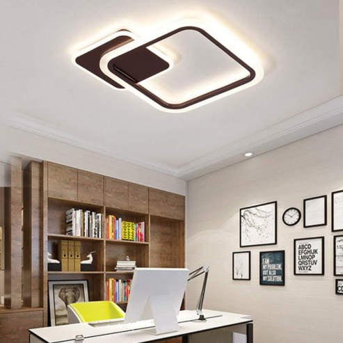 A modern home office with a sleek desk, computer, lime-green chair, built-in wooden shelves, and a plafonnier LED nordique avec capteur de mouvement PIR for automatic lighting. Black-and-white framed art decorates the light walls.