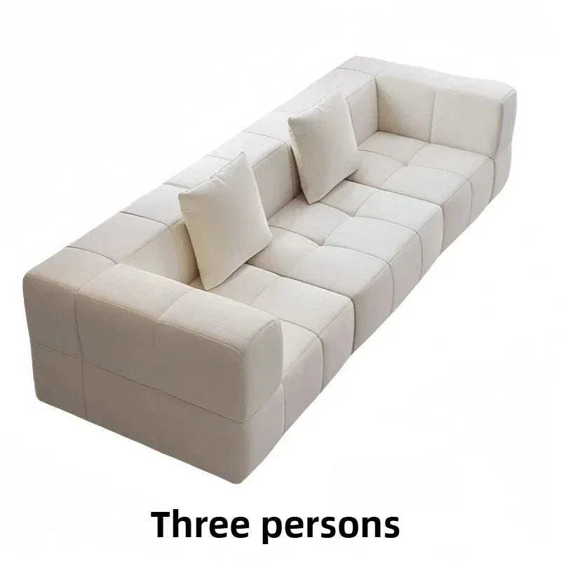 Canapé couleur crème, modulable, effet velvet avec coussins inclus.